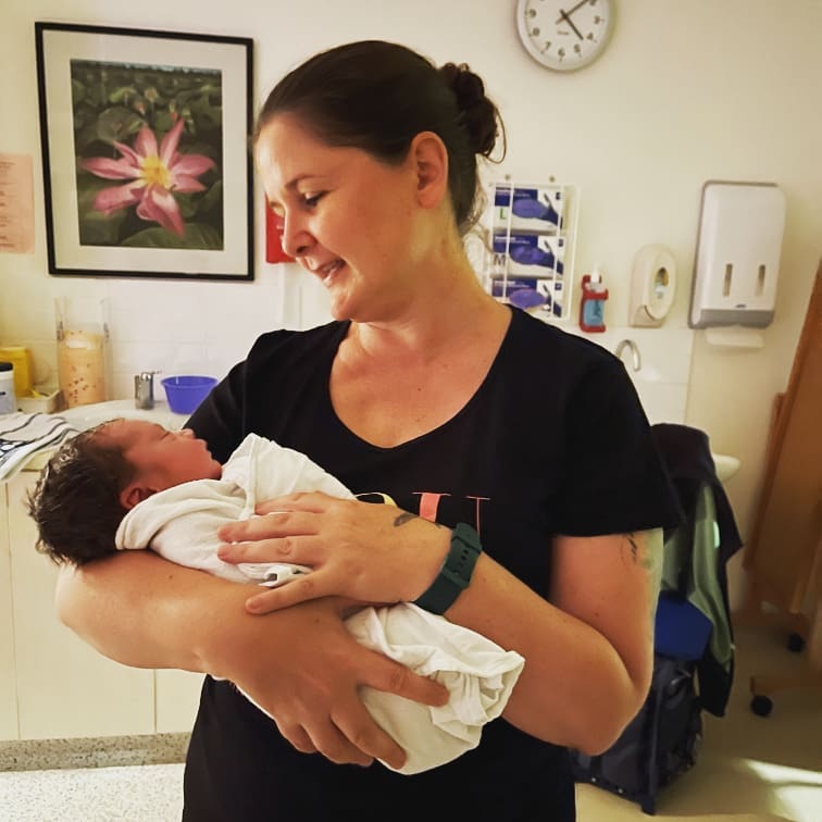Adelaide Doula Kelly from Elemental Beginnings holding her client's baby at Flinders Medical Centre