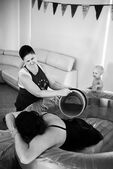 Kelly supporting a doula client during her labour by pouring warm water over her back during her homebirth in Adelaide