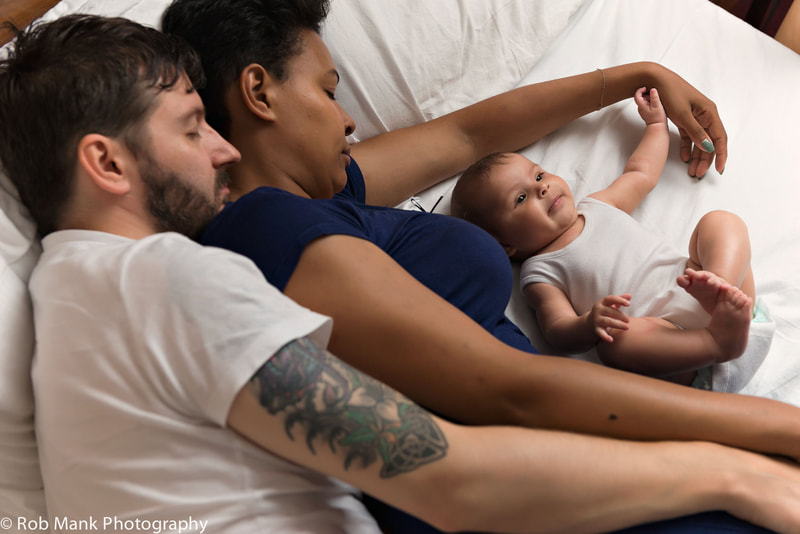 Couple sleeping in cuddle curl position next to awake baby who is bedsharing |Infant and Family Sleep Specialist Kelly Harper | Adelaide